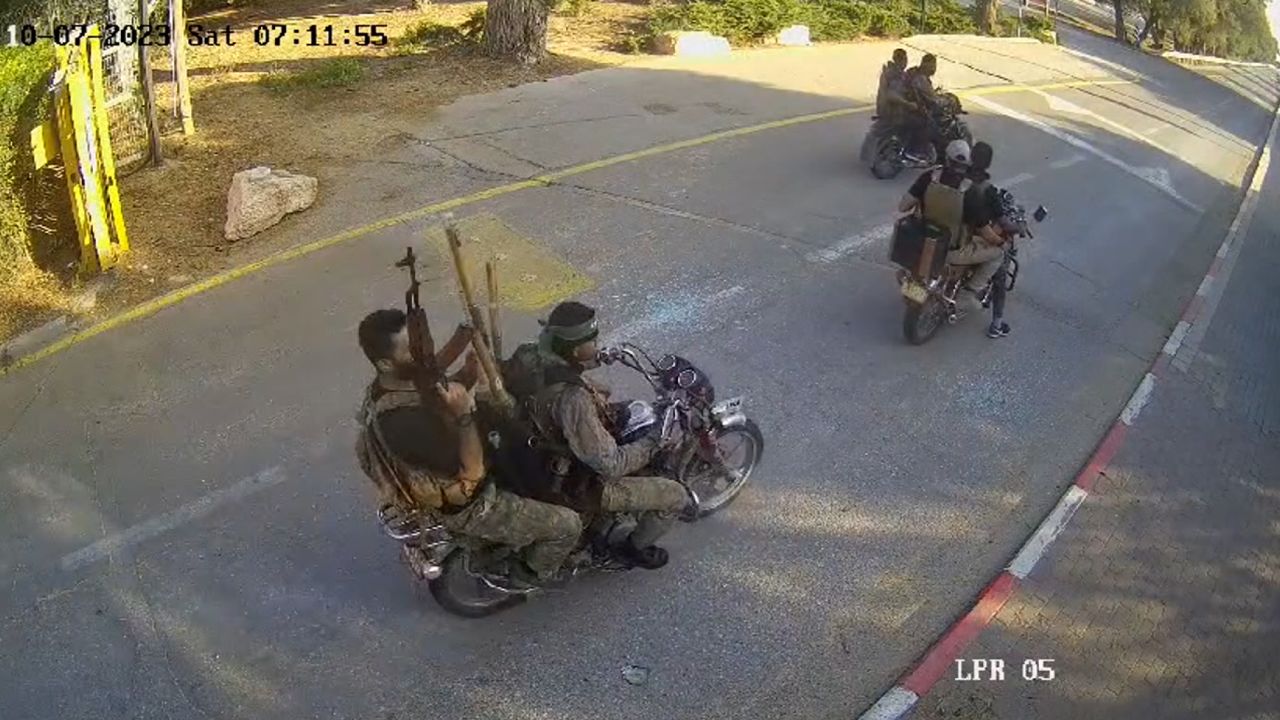 A screenshot from a video, geolocated by CNN, shows six Hamas militants arriving at Be'eri on Saturday morning local time.