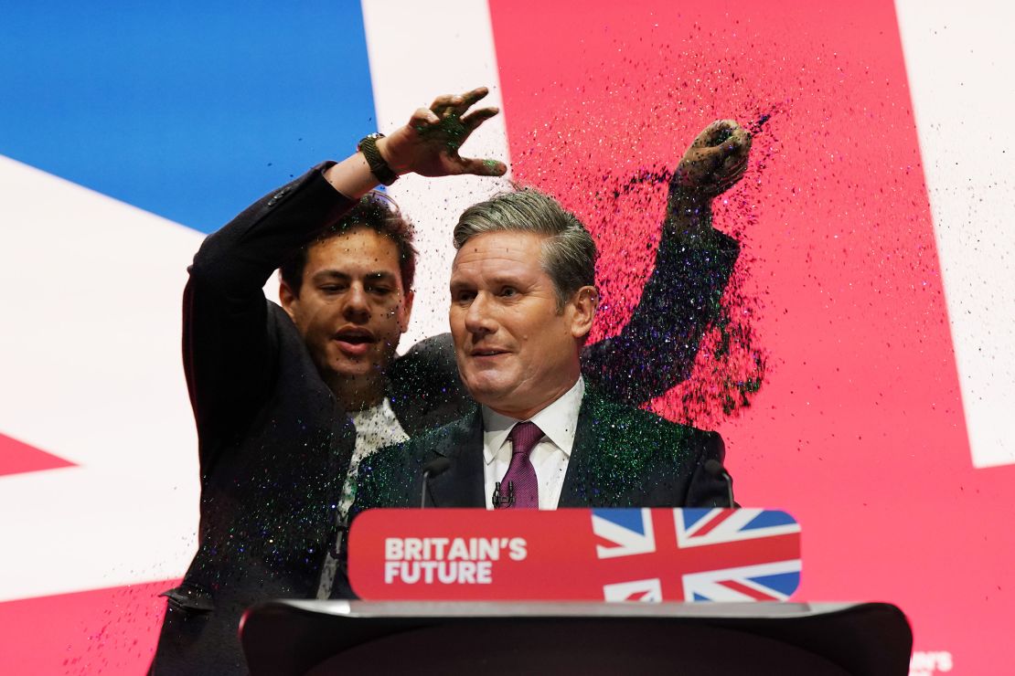 A protestor throws glitter over Labour party leader, Keir Starmer during the leader's speech at the Labour Party conference on October 10, 2023 in Liverpool, England. 