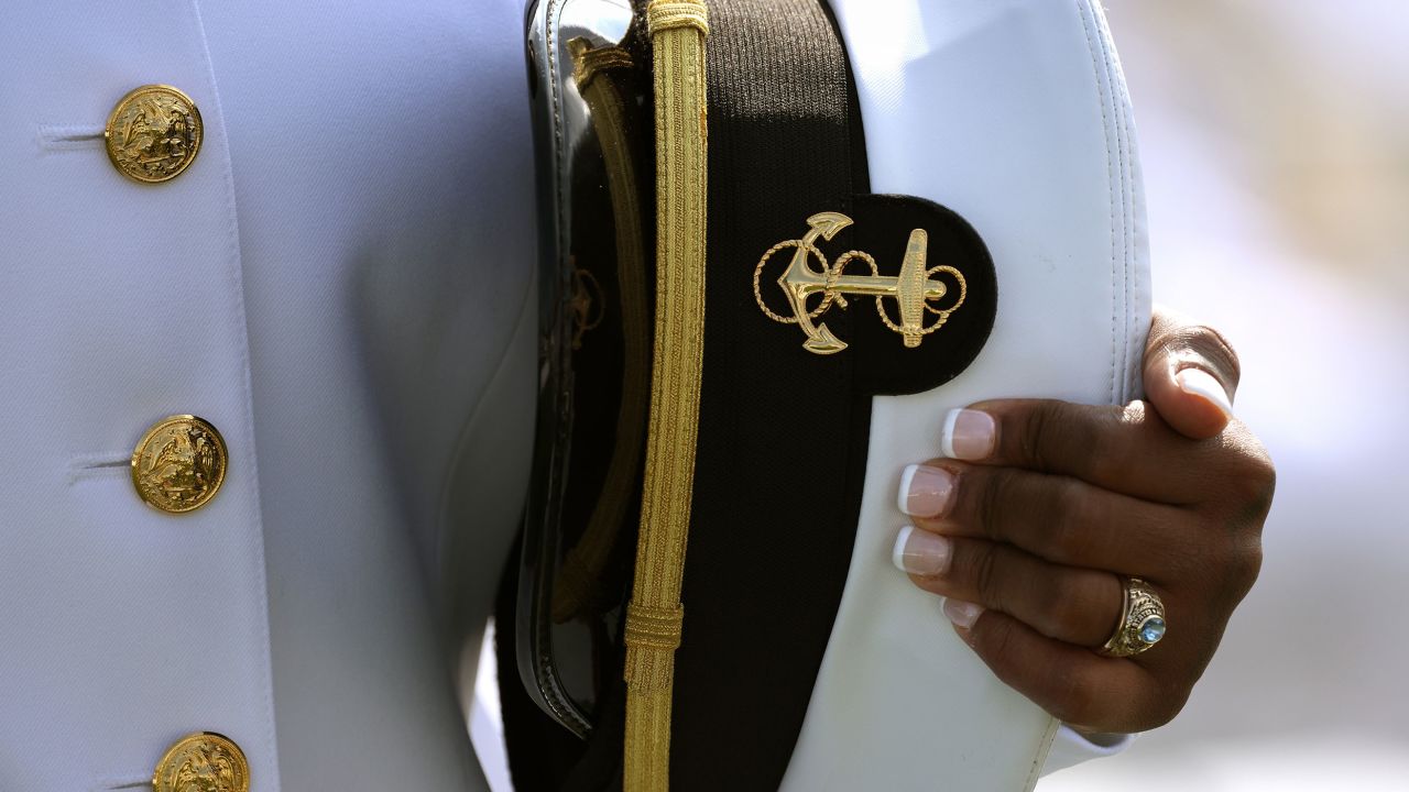 ANNAPOLIS, MARYLAND - MAY 28: A graduating Midshipmen holds her hat at the U.S. Naval Academy Graduation and Commissioning Ceremony at the Naval Academy on May 28, 2021 in Annapolis, Maryland. The graduating class of 1,084 will be commissioned as ensigns in the Navy or second lieutenants in the Marine Corps. (Photo by Kevin Dietsch/Getty Images)