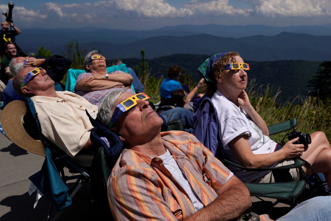 People watch as the solar eclipse approaches totality from Great Smoky Mountains National Park, Tennessee, on August 21, 2017.