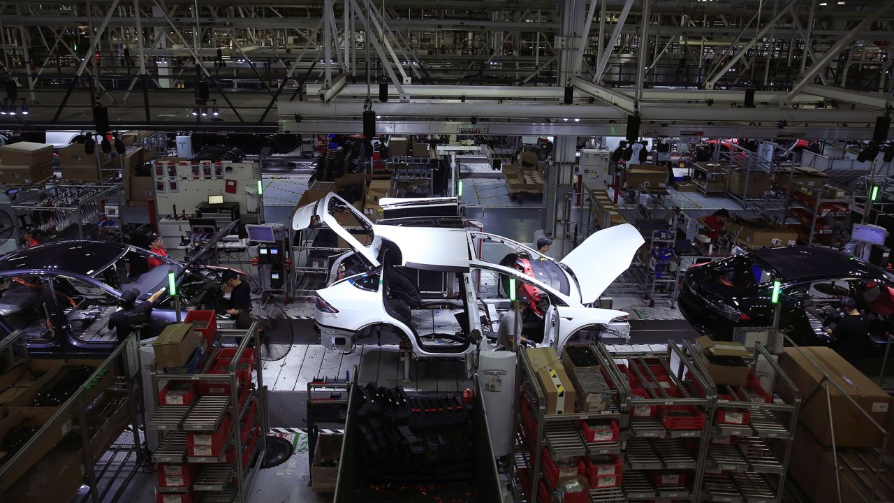 A Tesla Model X is worked on a factory line with Tesla X's and Tesla S's  at the Tesla factory on Wednesday, July 18,  2018 in Fremont, Calif.