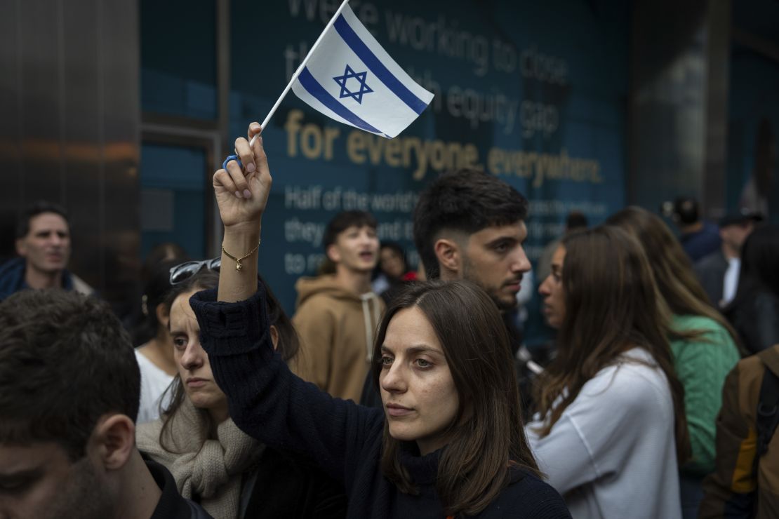 NEW YORK, NEW YORK - OCTOBER 8: A person holds an Israeli flag as opposing groups protest near the Israeli consulate on October 8, 2023 in New York City. On October 7, the Palestinian militant group Hamas launched a surprise attack on Israel from Gaza by land, sea, and air, killing over 600 people and wounding more than 2000. According to reports, Israeli soldiers and civilians have also been kidnapped by Hamas and taken into Gaza. The attack prompted a declaration of war by Israeli Prime Minister Benjamin Netanyahu, and ongoing retaliatory strikes by Israel on Gaza killing hundreds. (Photo by Adam Gray/Getty Images)