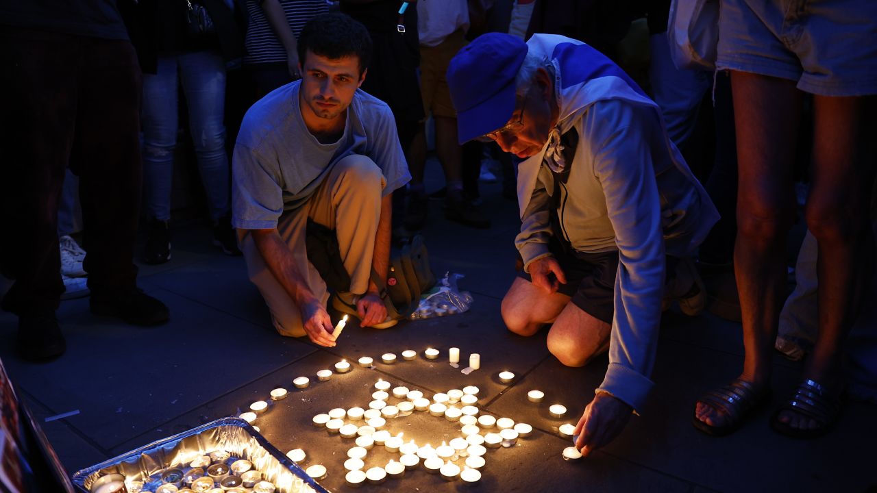 Members of the Jewish community light candles during a vigil for Israel at Downing Street in London on October 9.