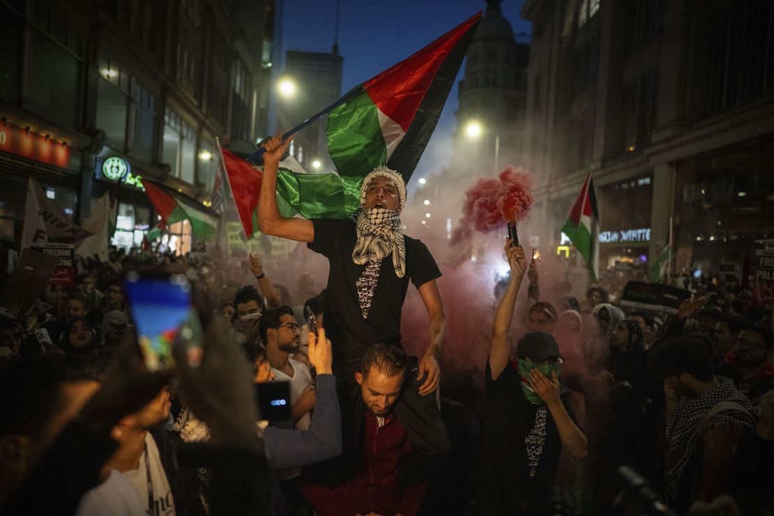 People take part in a pro-Palestinian demonstration at the Israeli Embassy in London on October 9.