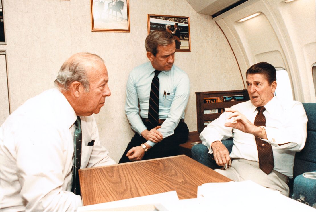 Secretary of State George Shultz and National Security Advisor-designate Robert McFarlane listen to Reagan speak about the ongoing issues in Beirut on Air Force One on October 23, 1983.