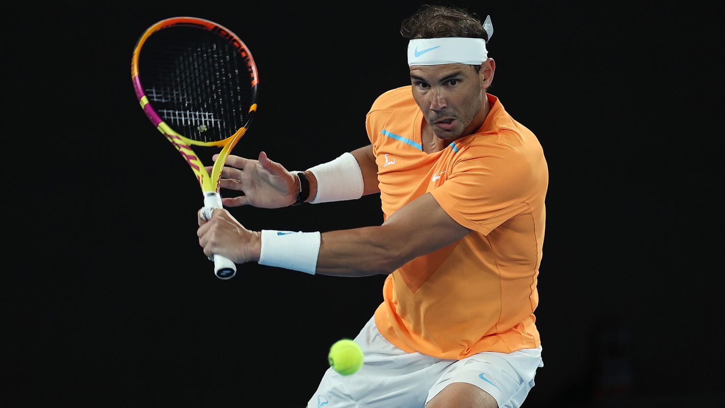 MELBOURNE, AUSTRALIA - JANUARY 18: Rafael Nadal of Spain plays a backhand in their round two singles match against Mackenzie McDonald of the United States during day three of the 2023 Australian Open at Melbourne Park on January 18, 2023 in Melbourne, Australia. (Photo by Cameron Spencer/Getty Images)