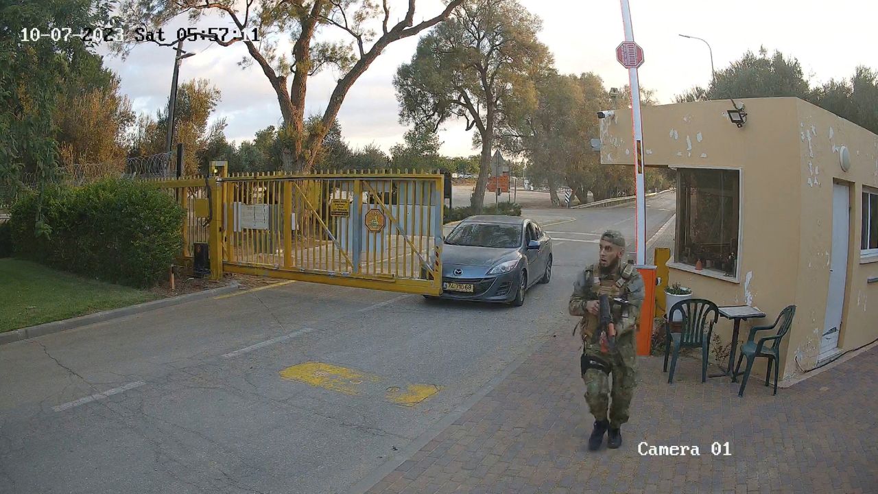 CCTV footage shows one of two Hamas Islamist militants entering Be'eri kibbutz after firing on a car filled with local residents