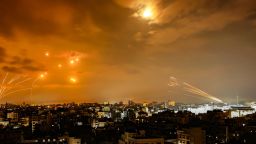 Rockets fired by Palestinian militants from Gaza City are intercepted by the Israeli Iron Dome defense missile system in the early hours of October 8.