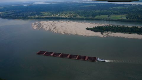 In this aerial photo, a tugboat pushing barges navigates around a sandbar during low water levels on the Mississippi River between Baton Rouge, La., and Reserve, La., in Livingston Parish, La., Thursday, Sept. 14, 2023. (AP Photo/Gerald Herbert)