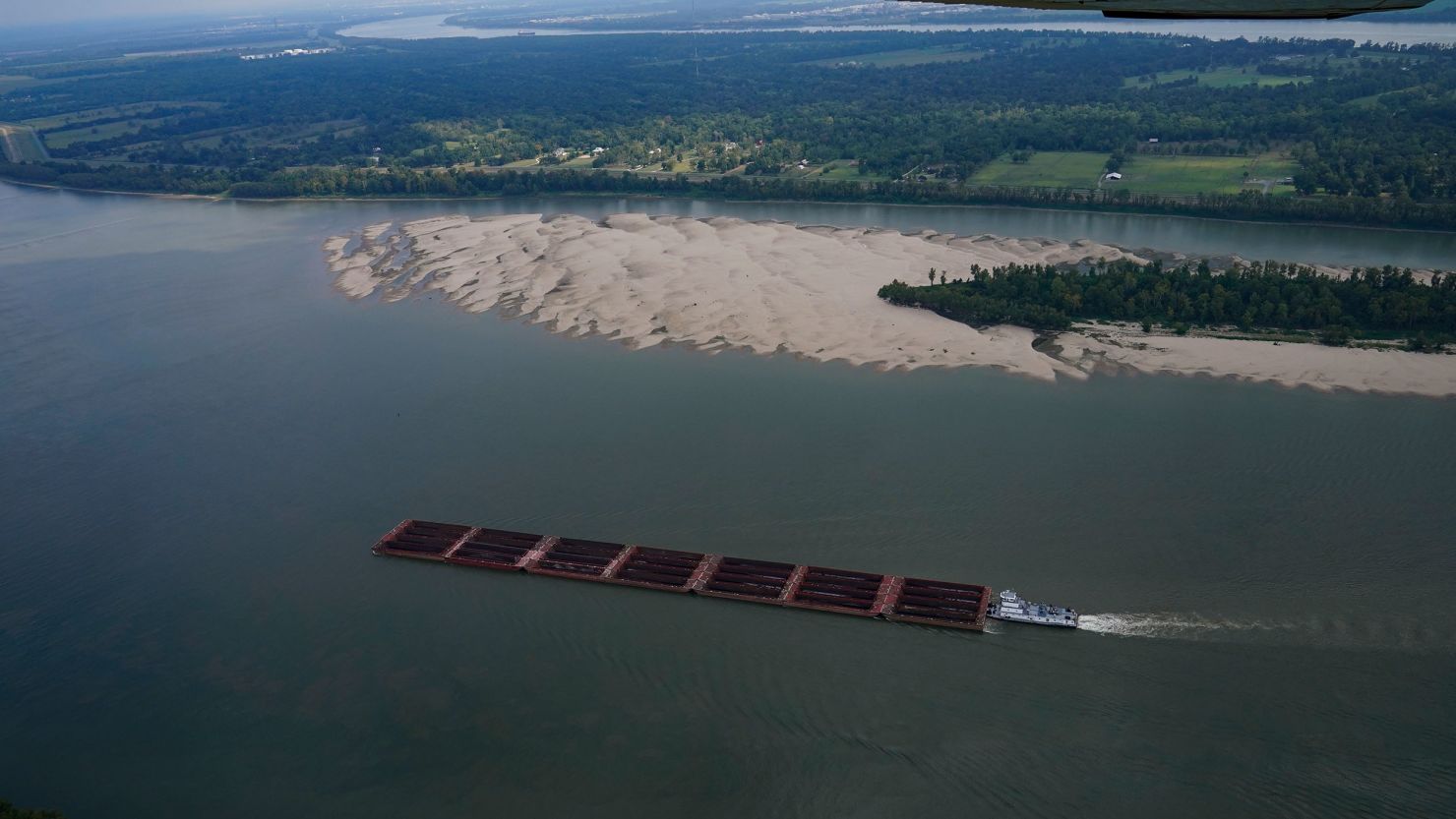 A tugboat pushing barges navigates around a sandbar during low water levels on the Mississippi River between Baton Rouge and Reserve, Louisiana, on September 14, 2023.