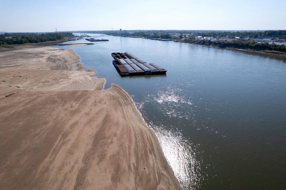 Barges float in the Mississippi River as a portion of the riverbed is exposed, on September 15, 2023, in St. Louis, Missouri.