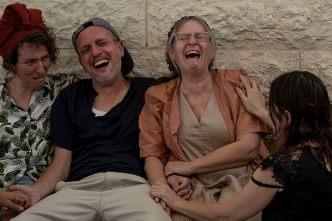 Itzik and Miriam Shafir, center, mourn during their son's funeral at a cemetery in Modiin Maccabim, Israel, on October 11. Their son, Dor Shafir, and his girlfriend, Savion Kiper, were killed during <a href="https://www.cnn.com/2023/10/07/middleeast/israel-gaza-fighting-hamas-attack-music-festival-intl-hnk/index.html" target="_blank">Hamas' attack on a music festival</a> on Saturday.