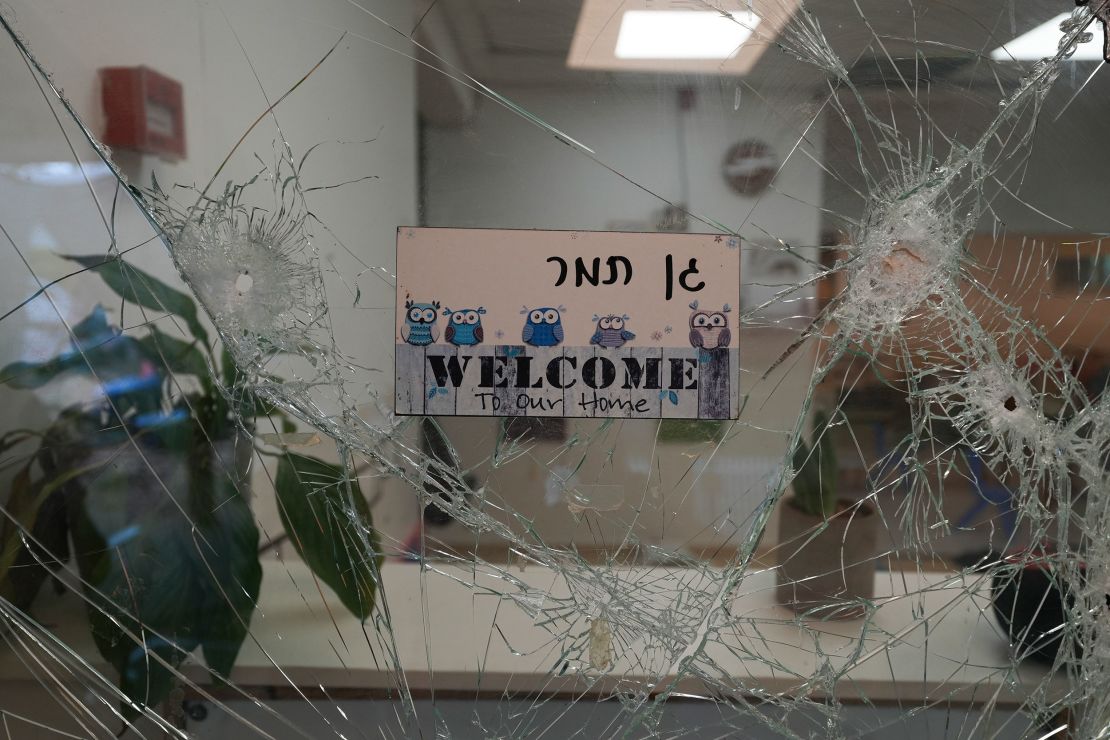 A bullet-shuttered window of the entrance to a kindergarten is seen in Kibbutz Be'eri on Wednesday, Oct. 11, 2023