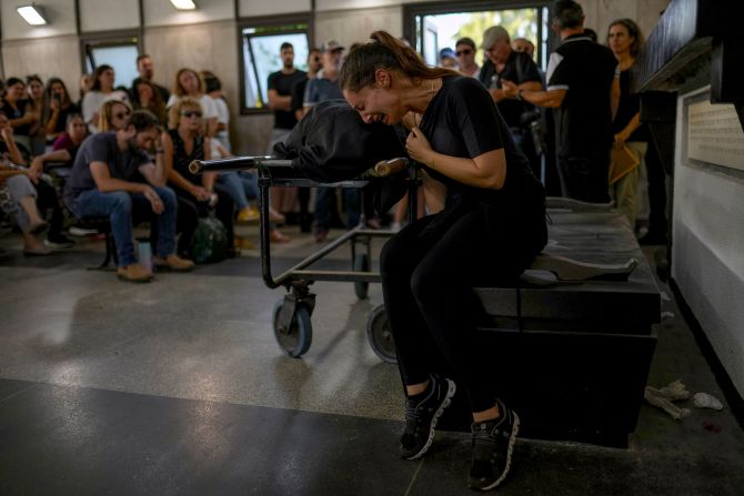 Mourners react beside the body of Mapal Adam during her funeral in Tel Aviv, Israel, on October 11.