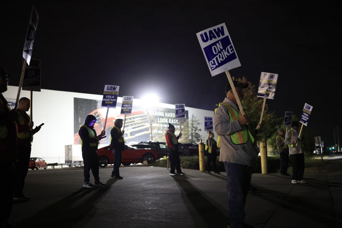 Factory workers and UAW union members form a picket line outside the Ford Motor Co. Kentucky Truck Plant in the early morning hours on October 12, 2023 in Louisville, Kentucky. 
