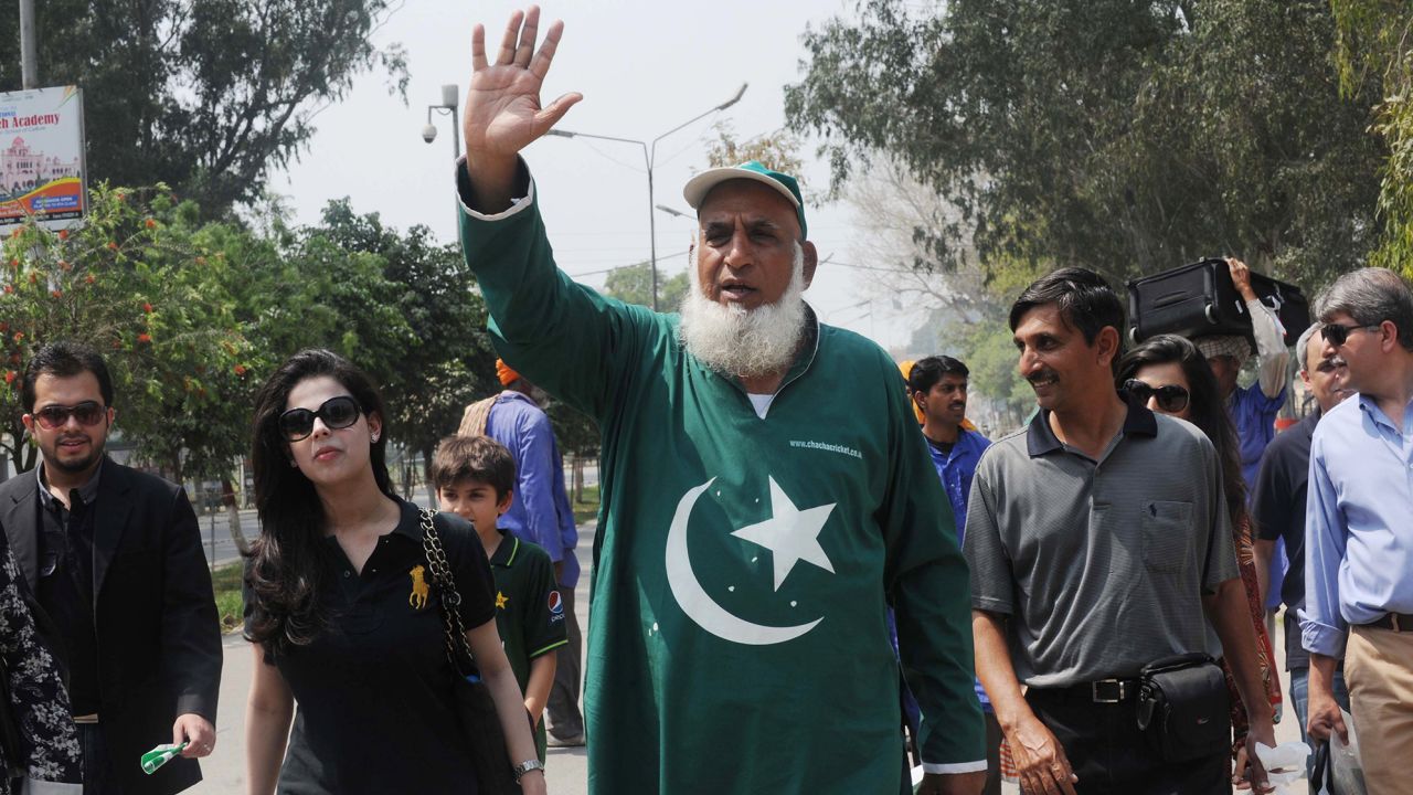 Chaudhry Abdul Jalil, popularly known as Chacha Cricket, waves after crossing the India-Pakistan border in Wagah on March 29, 2011, on the eve of the India-Pakistan Cricket World Cup semi-final match.