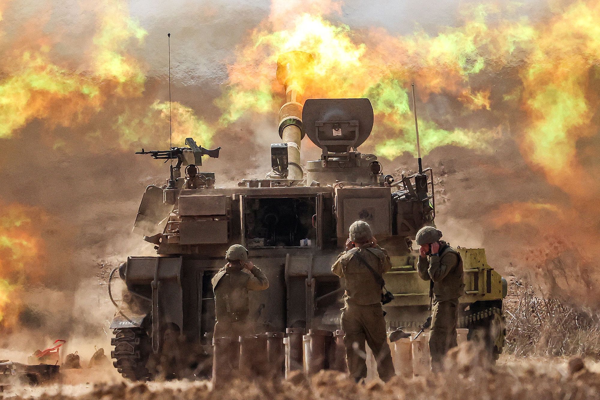 An Israeli army self-propelled howitzer fires rounds near the border with Gaza in southern Israel on October 11.