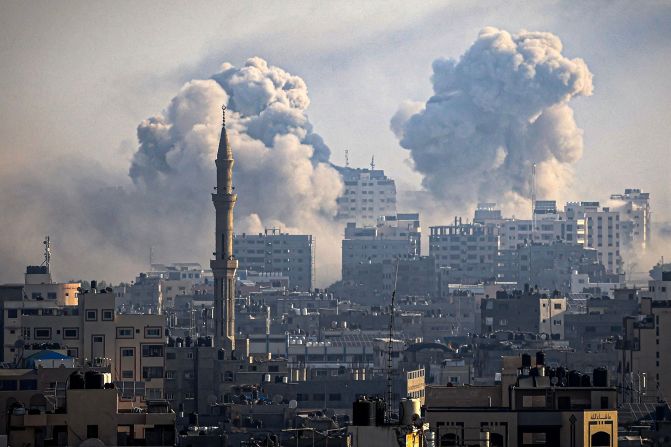 Smoke plumes billow during Israeli air strikes in Gaza City on October 12.