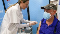 A pharmacist administers the new updated COVID Monovalent vaccine at a Walgreen?s Pharmacy in the Ukrainian Village in Chicago on October 6, 2023. The new vaccine is a closer match to currently circulating variants and is recommended for everyone 6 months and older. (Photo By: Alexandra Buxbaum/Sipa USA)