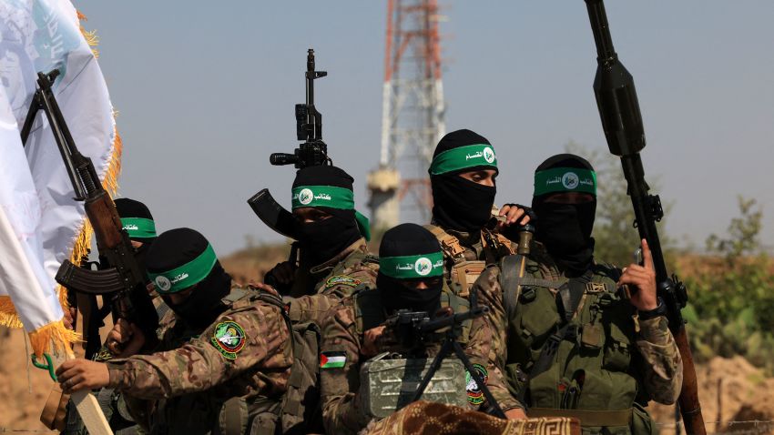 Palestinian fighters of the al-Qassam Brigades, the armed wing of the Hamas movement, take part in a military parade to mark the anniversary of the 2014 war with Israel, near the border in the central Gaza Strip on July 19, 2023. (Photo by MAHMUD HAMS / AFP) (Photo by MAHMUD HAMS/AFP via Getty Images)