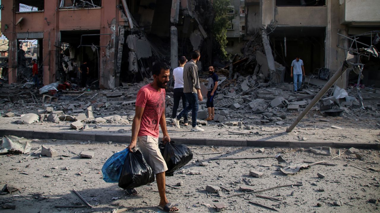 Palestinian citizens inspect damage to their homes, which were destroyed by Israeli airstrikes in the Karama area, in northern Gaza, on Wednesday.