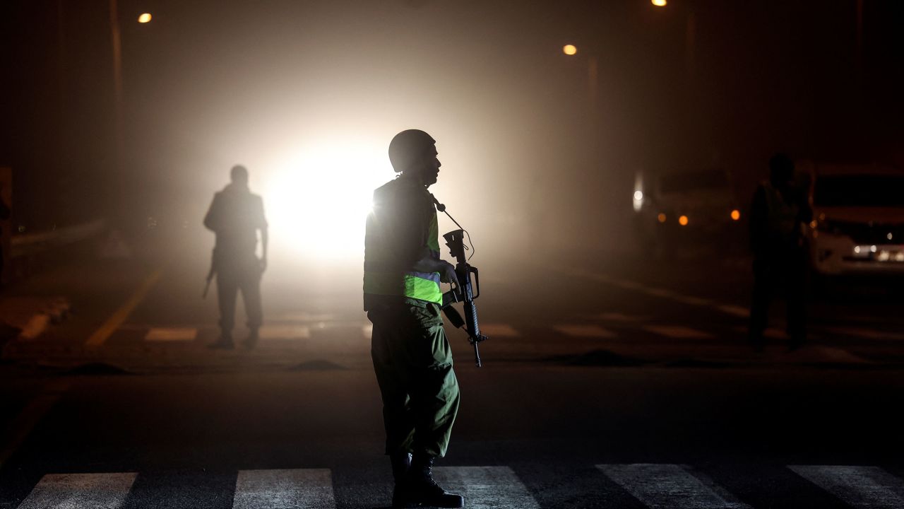 An Israeli soldier is silhouetted on a road near the border with Gaza, October 12, 2023.