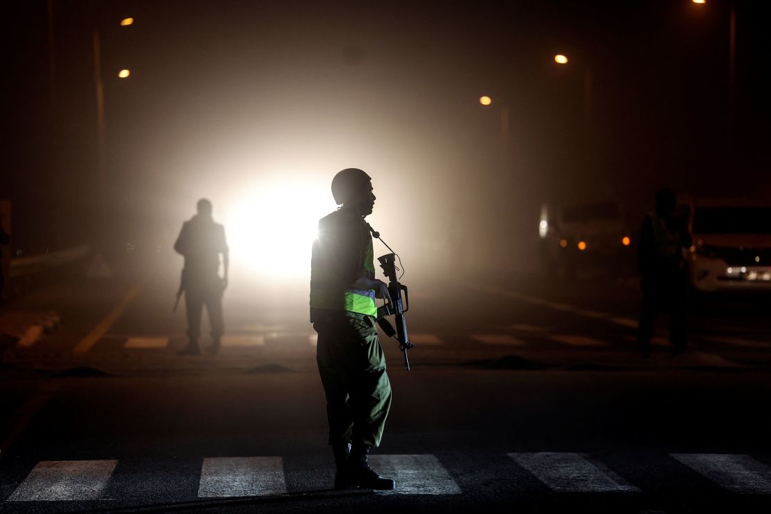 An Israeli soldier is silhouetted on a road near the border with Gaza, October 12, 2023.
