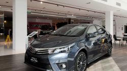 A Corolla Altis sedan stands on display at a Toyota Motor Corp. dealership in Singapore, on Tuesday, July 12, 2016. Buyers in one of the world's most expensive car markets just missed their chance to snag one at the cheapest price in five years. Car-ownership permit costs in Singapore have gained since February after ride-hailing companies obtained licenses for their fleets and the regulator eased rules on vehicle loans in May. Photographer: Ore Huiying/Bloomberg via Getty Images