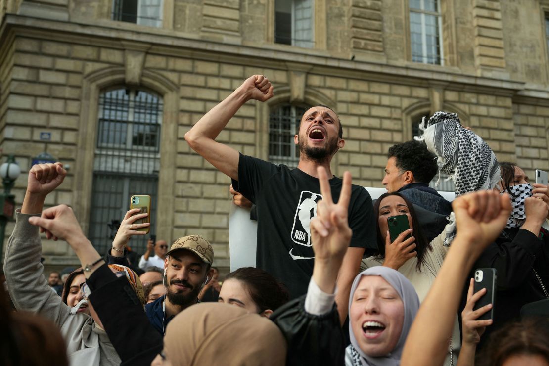 Protestors chant as they gather at Place de la Republique on October 12, 2023. 