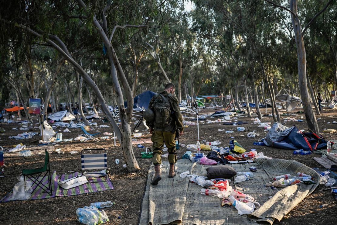 An Israeli soldier patrols near the Nova music festival grounds near Be'eri, Israel, on October 12.EDITORS NOTE: Graphic content / An Israeli soldier patrols on October 12, 2023 near Kibbutz Beeri, the place where 270 revellers were killed by militants during the Supernova music festival on October 7. Thousands of people, both Israeli and Palestinians have died since October 7, 2023, after Palestinian Hamas militants entered Israel in a surprise attack leading Israel to declare war on Hamas in the Gaza Strip enclave the following day. (Photo by Aris MESSINIS / AFP) (Photo by ARIS MESSINIS/AFP via Getty Images)