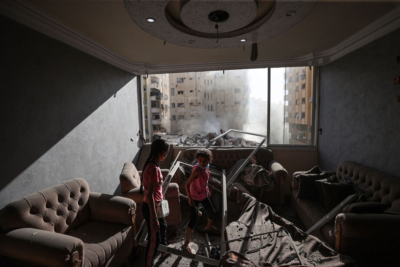 Children are seen in a damaged house in Gaza after Israeli airstrikes on Saturday, October 7.