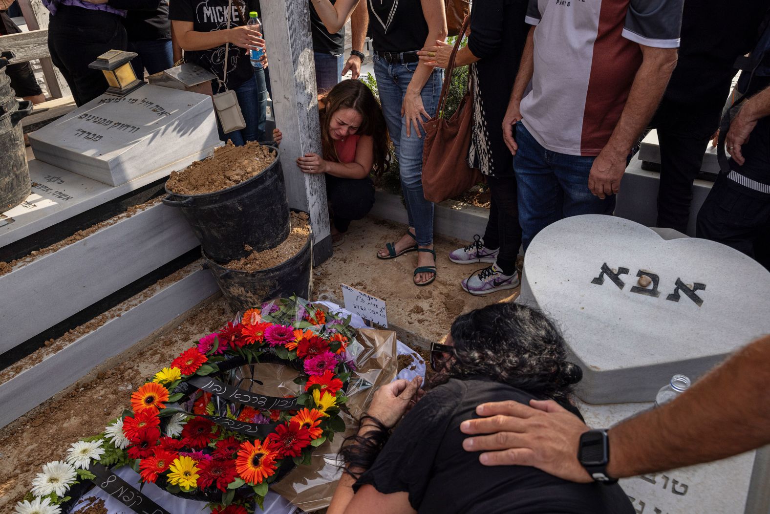 People mourn at the grave of paramedic Amit Man during her funeral in Netivot, Israel, on Tuesday, October 10. She was fatally shot along with patients she was treating in Be'eri, Israel. The self-sustaining farming community near Gaza was <a href="index.php?page=&url=https%3A%2F%2Fwww.cnn.com%2F2023%2F10%2F10%2Fmiddleeast%2Fisrael-beeri-bodies-found-idf-intl-hnk%2Findex.html" target="_blank">one of the first places targeted by Hamas militants</a> on Saturday.