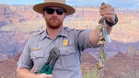 A Grand Canyon National Park Ranger holds up love locks.