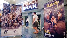 Fans pass posters at a movie theater in Shanghai, China, August 13, 2023. The poster on the left shows Creation of the Gods I: Kingdom of Storms, while the one on the right is No More Bets.
