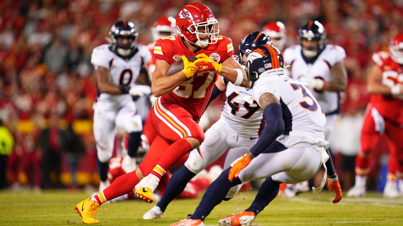 Travis Kelce #87 of the Kansas City Chiefs carries the ball against the Denver Broncos at GEHA Field at Arrowhead Stadium on October 12, 2023 in Kansas City, Missouri.