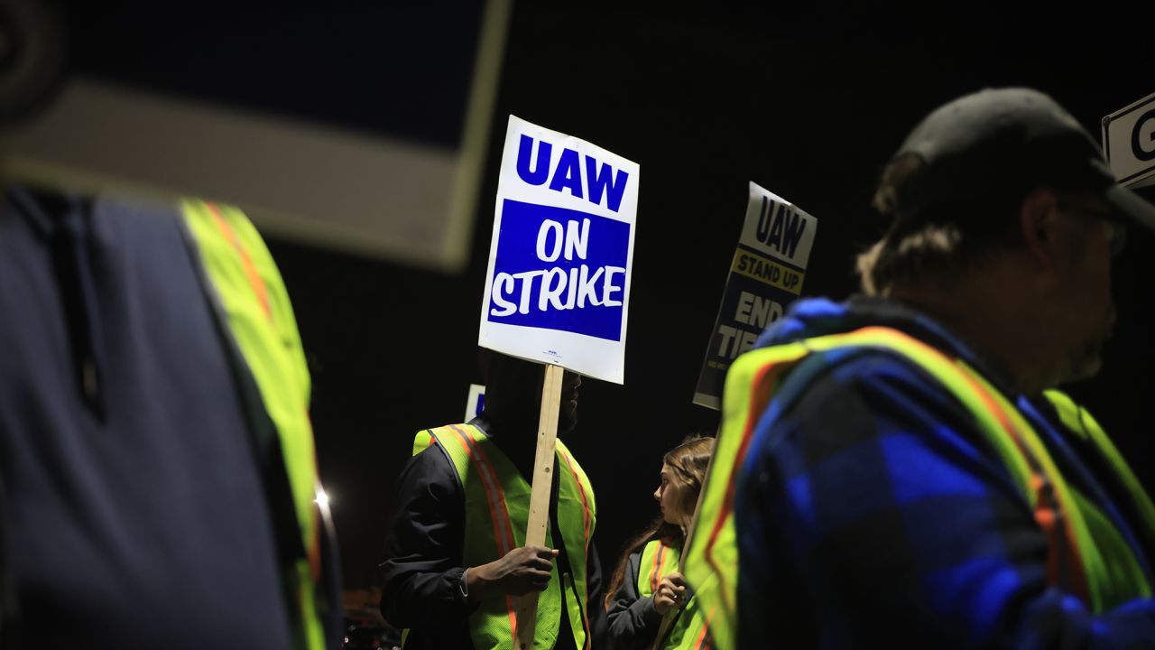 Factory workers and UAW union members form a picket line outside the Ford Motor Co. Kentucky Truck Plant in the early morning hours on October 12, 2023 in Louisville, Kentucky. UAW leadership announced that the Kentucky Truck Plant would be the latest automotive manufacturing facility to join the nationwide strike.
