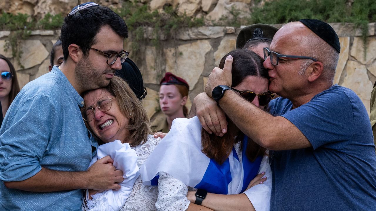 The mother (L), sister (R) and immediate family of Valentin (Eli) Ghnassia, 23, who was killed in a battle with Hamas militants at Kibbutz Be'eeri near the Israeli border with the Gaza Strip, react during his funeral, October 12, 2023 in Jerusalem, Israel. 