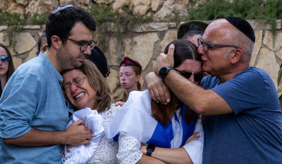 The mother (L), sister (R) and immediate family of Valentin (Eli) Ghnassia, 23, who was killed in a battle with Hamas militants at Kibbutz Be'eeri near the Israeli border with the Gaza Strip, react during his funeral,  October 12, 2023 in Jerusalem, Israel. 