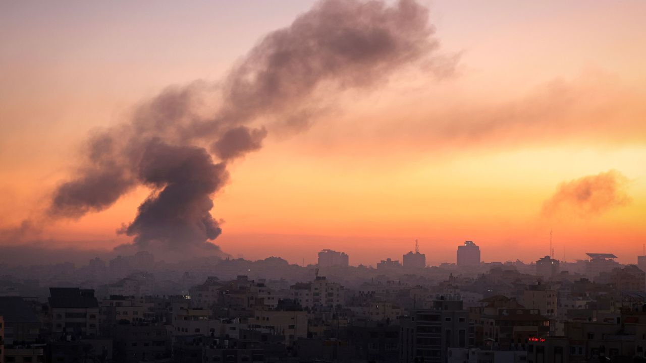 Fire and smoke rise above buildings in Gaza City during an Israeli air strike on October 13, as raging battles between Israel and Hamas continue for the sixth consecutive day. 