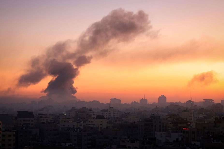 Fire and smoke rise above buildings in Gaza City during an Israeli air strike on October 13.