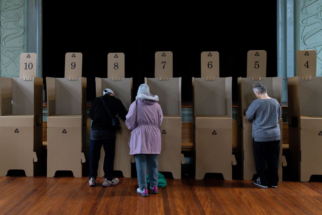 MELBOURNE, AUSTRALIA - OCTOBER 14: Voters at a polling box cast their vote at a polling centre on October 14, 2023 in Melbourne, Australia. A referendum for Australians to decide on an indigenous voice to parliament was held on October 14, 2023 and compelled all Australians to vote by law. Early voting began on October  2, and activity has been intensifying in both the YES and NO camps, with multiple polls showing the YES campaign headed for defeat nationally. Australia requires a "double majority" of both the states and voters across the country to trigger constitutional changes, with most referendums in the past having failed. (Photo by Asanka Ratnayake/Getty Images)