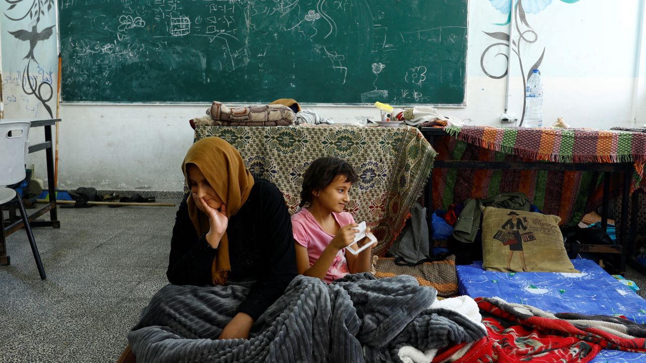 Palestinians, who fled their houses amid Israeli strikes, shelter at a United Nations-run school in Khan Younis in the southern Gaza Strip, October 14.