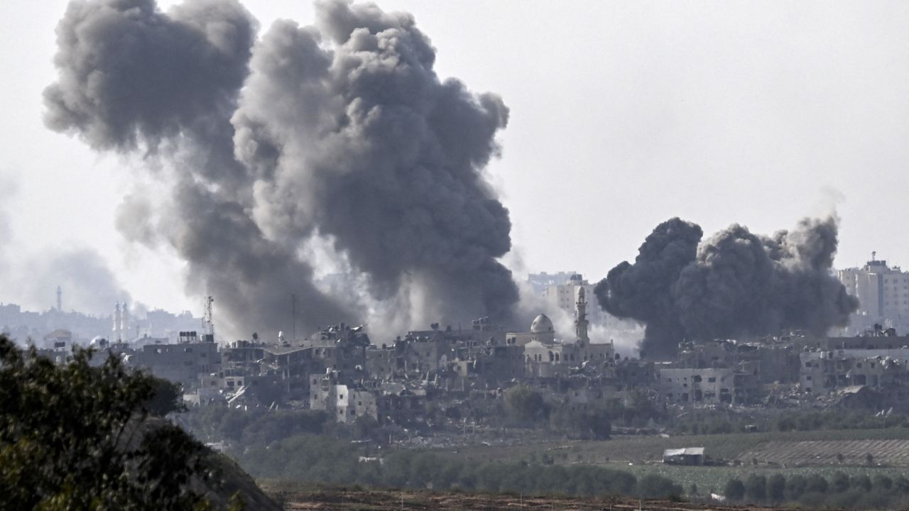 A picture taken from Sderot shows smoke plumes rising above buildings during an Israeli strike on the northern Gaza Strip on October 14.