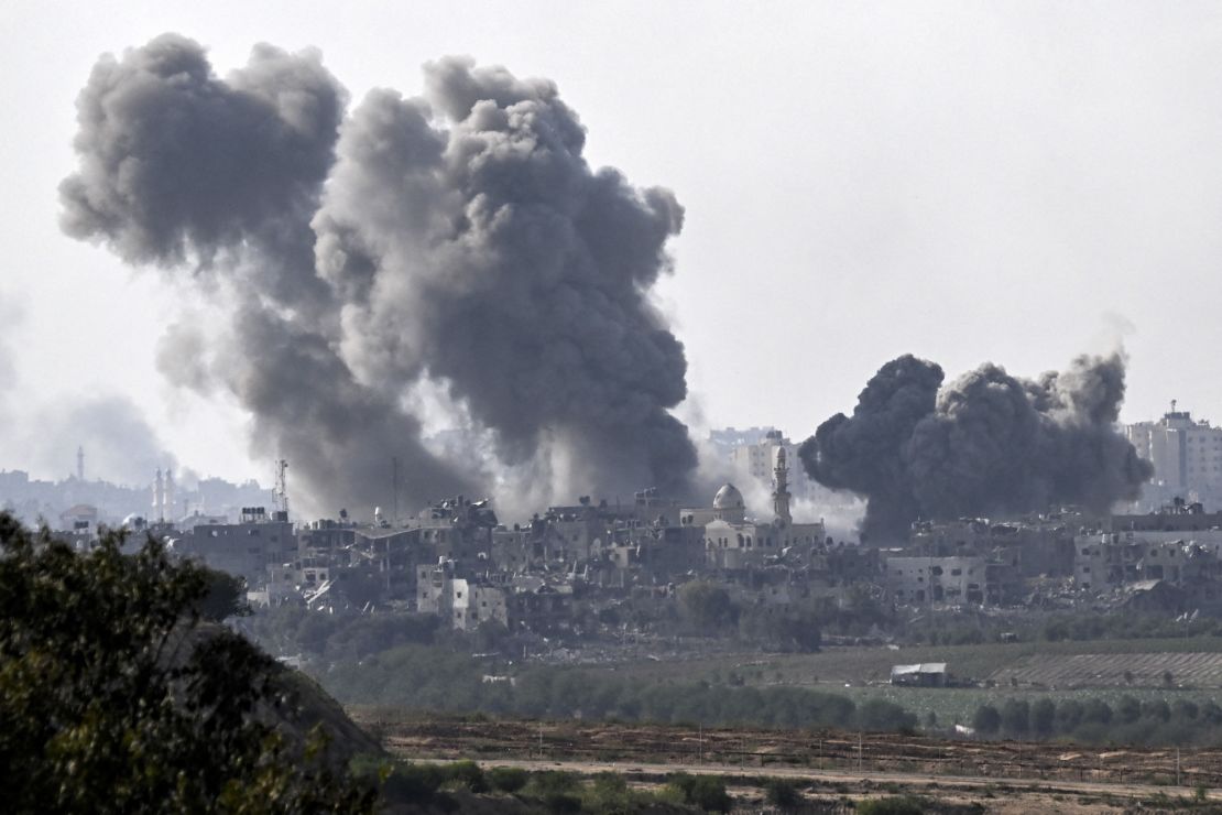 A picture taken from Sderot shows smoke plumes rising above buildings during an Israeli strike on the northern Gaza Strip on October 14.