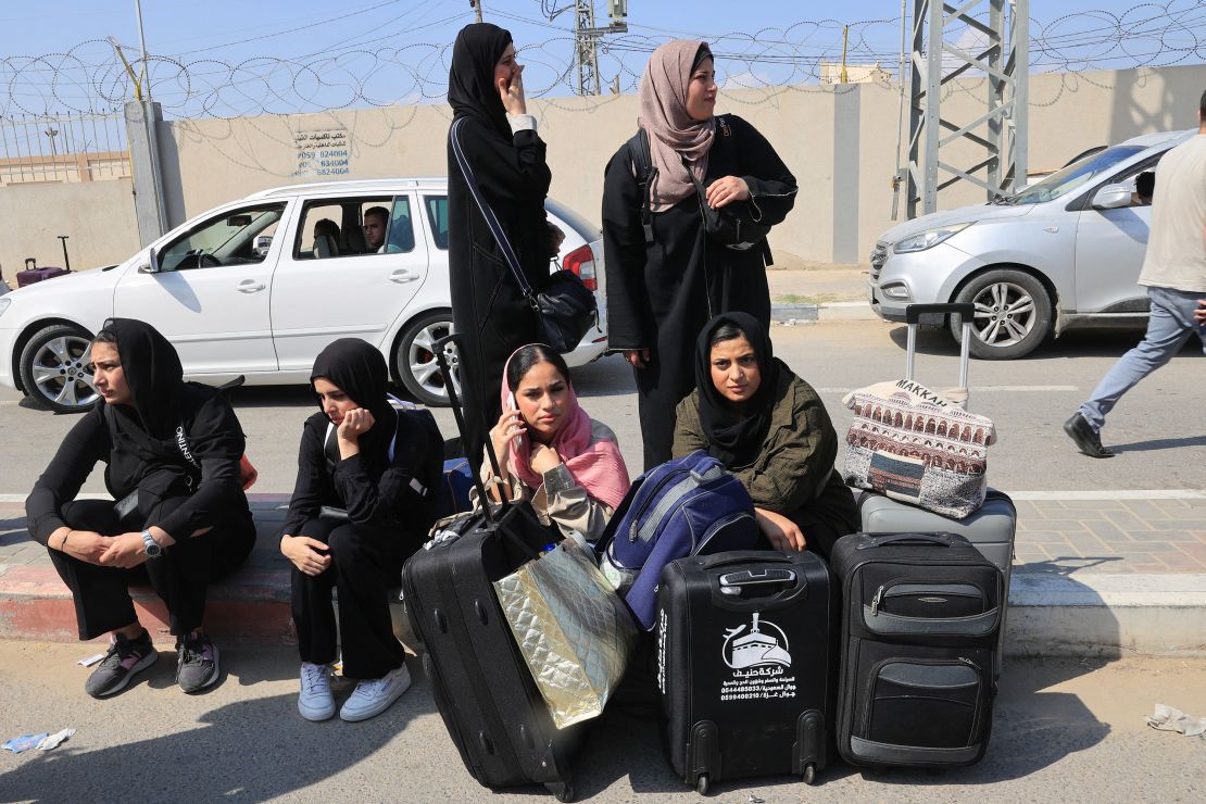 People carrying foreign passports wait at the Rafah gate hoping to cross into Egypt as Israel's attacks on the Gaza Strip continues on October 14, 2023.