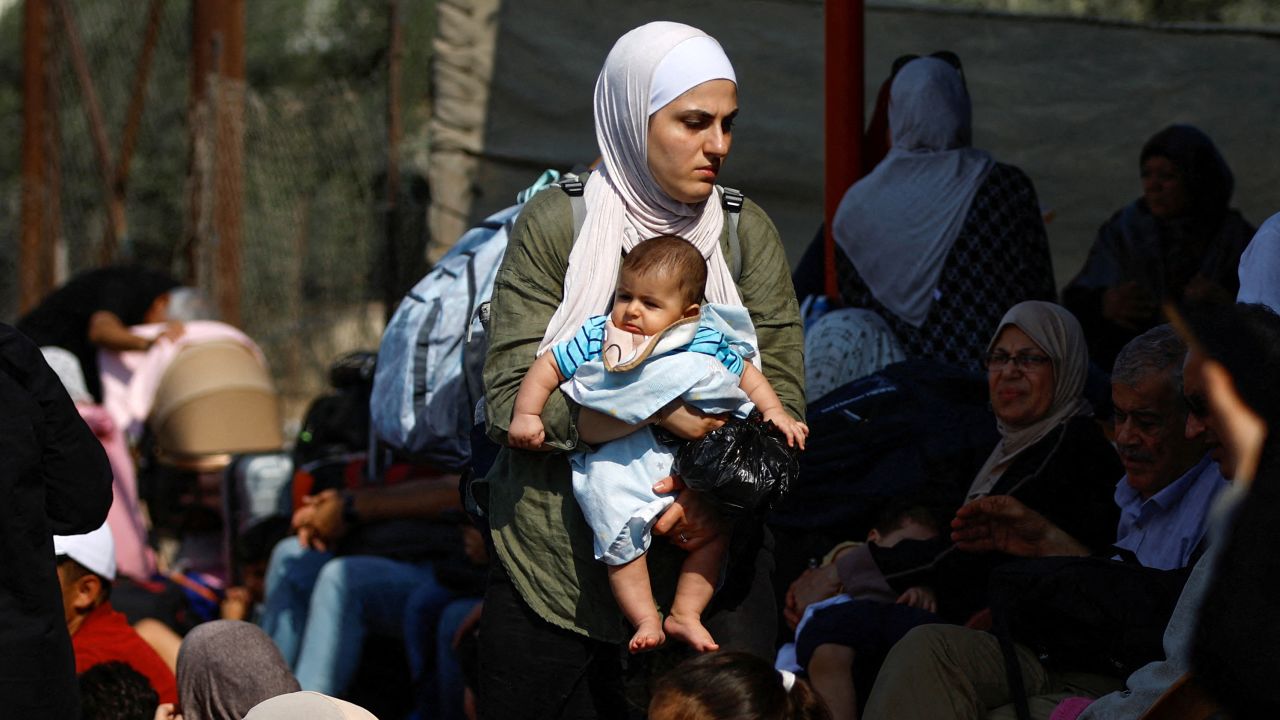 Palestinians with dual citizenship wait outside Rafah border crossing with Egypt.