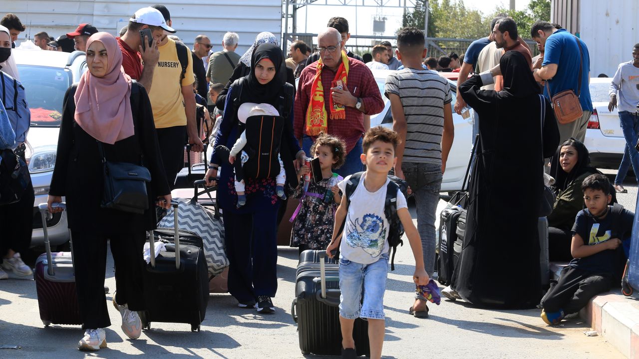 Palestinians wait at the Rafah border crossing.