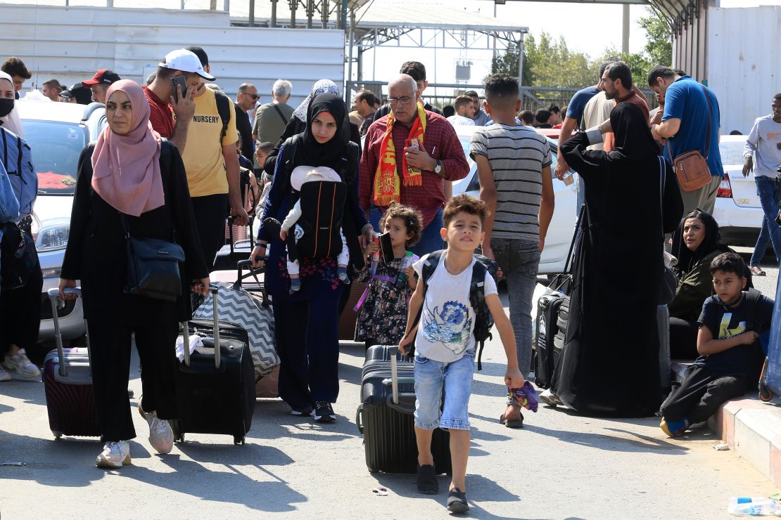Palestinians wait at the Rafah border crossing.