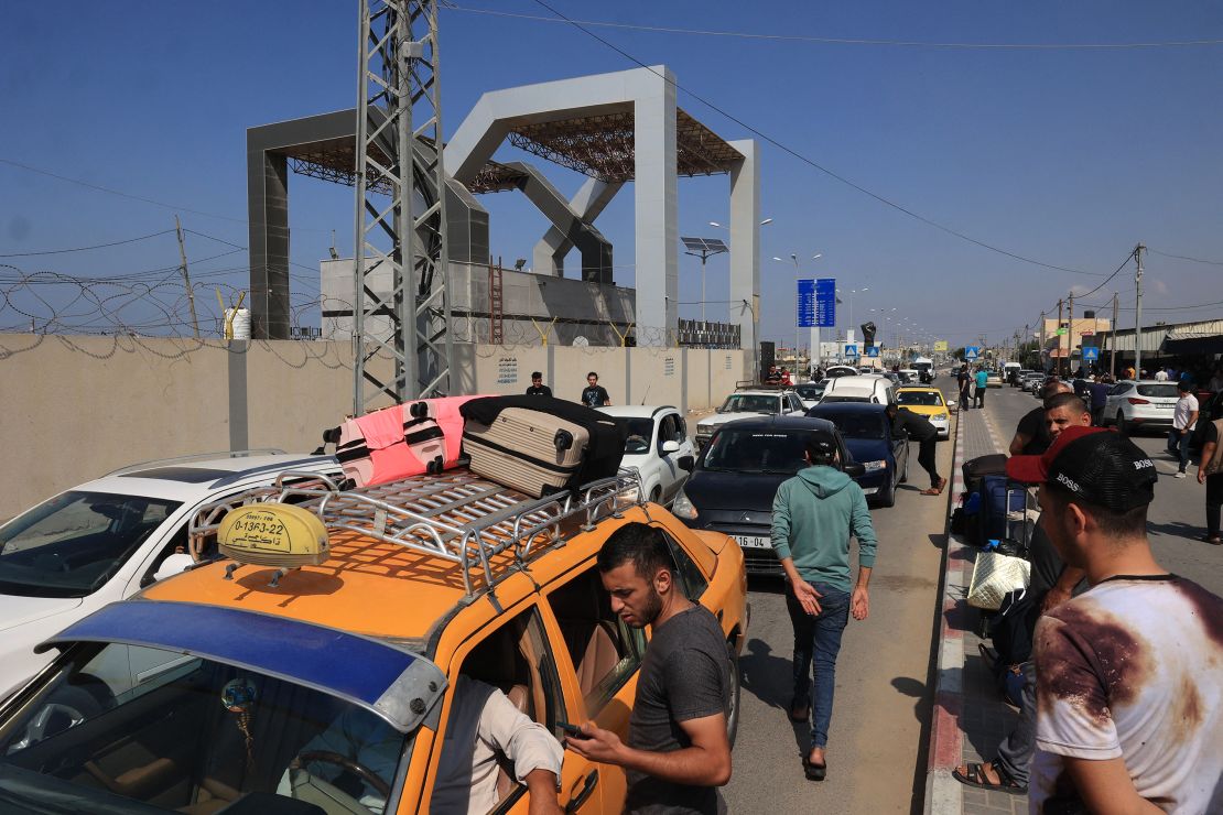 Palestinians with foreign passports arrive at the Rafah gate hoping to cross into Egypt as Israel's attacks on the Gaza Strip continues on October 14.. 