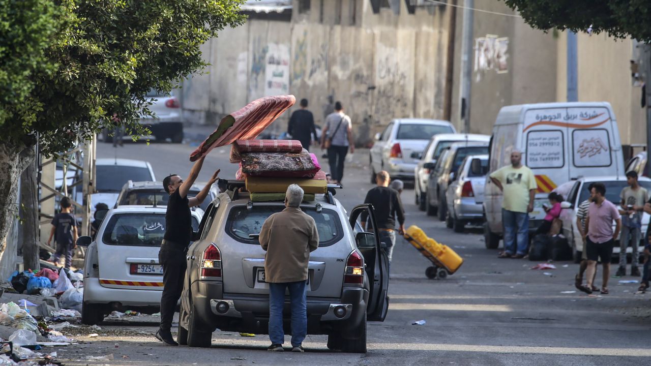Residents of Gaza City load a car with their belongings as they begin to evacuate on October 14. 